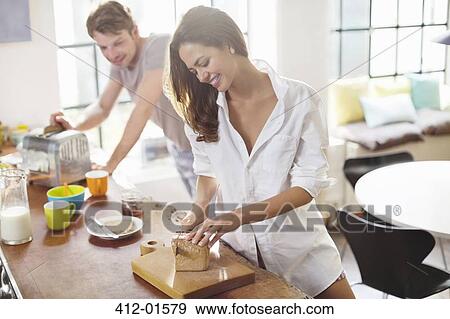 Couple making breakfast in kitchen View Large Photo Image Stock Photo - Couple making breakfast in kitchen. Fotosearch