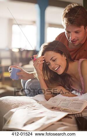 Couple reading newspaper together View Large Photo Image Picture - Couple reading newspaper together. Fotosearch
