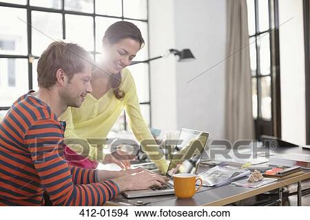Picture - Couple working on laptop together. Fotosearch