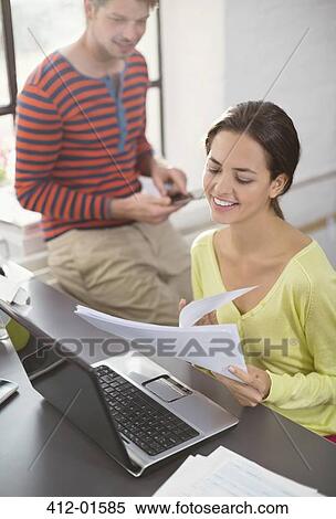 Couple working together at desk View Large Photo Image Stock Photography - Couple working together at desk. Fotosearch