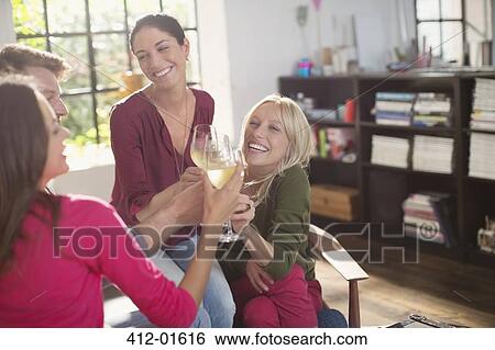 Stock Photograph - Friends toasting each other with white wine. Fotosearch