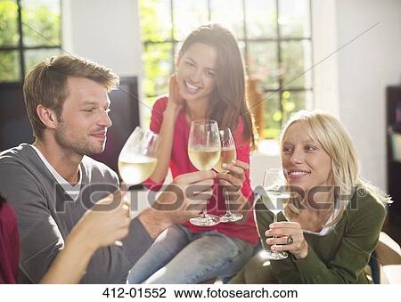 Friends toasting each other with wine View Large Photo Image Stock Image - Friends toasting each other with wine. Fotosearch