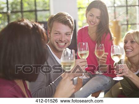 Stock Photograph - Friends toasting each other with wine. Fotosearch