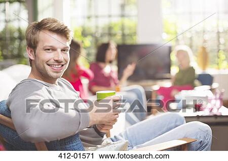 Man having cup of coffee in armchair View Large Photo Image Stock Image - Man having cup of coffee in armchair. Fotosearch