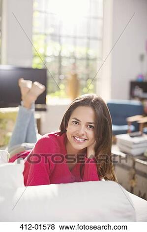 Smiling woman laying on bed View Large Photo Image Stock Photo - Smiling woman laying on bed. Fotosearch