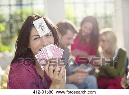Smiling woman playing card game View Large Photo Image Stock Image - Smiling woman playing card game. Fotosearch