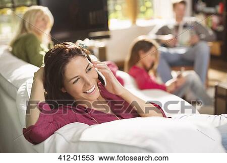 Woman talking on phone on sofa View Large Photo Image Stock Image - Woman talking on phone on sofa. Fotosearch