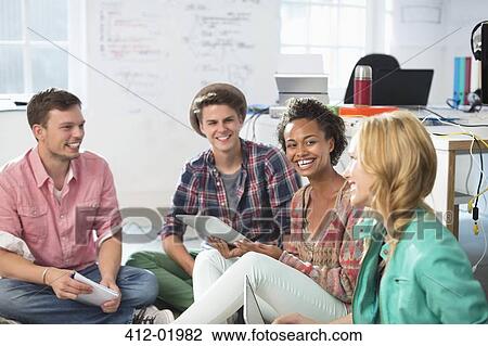 Stock Image - Business people laughing in meeting. Fotosearch