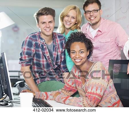 Business people smiling at desk View Large Photo Image Picture - Business people smiling at desk. Fotosearch