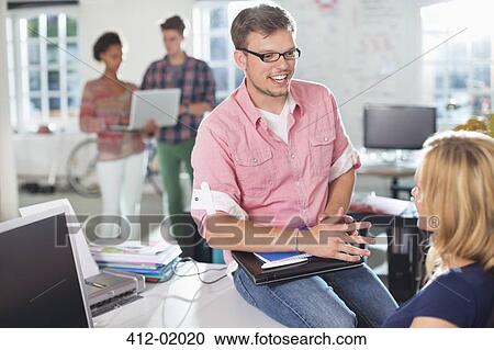Business people talking at desk View Large Photo Image Stock Image - Business people talking at desk. Fotosearch