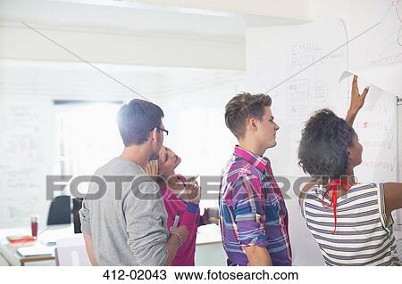 Stock Image - Business people talking in meeting. Fotosearch