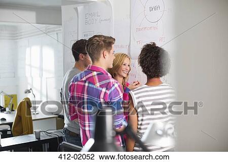 Stock Image - Business people talking in meeting. Fotosearch