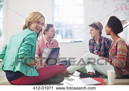 Stock Image - Business people talking in office. Fotosearch