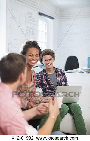 Stock Image - Business people talking in office. Fotosearch