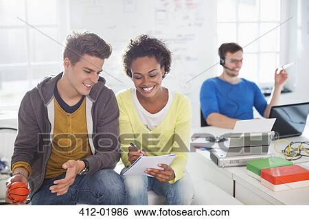 Stock Photograph - Business people talking in office. Fotosearch