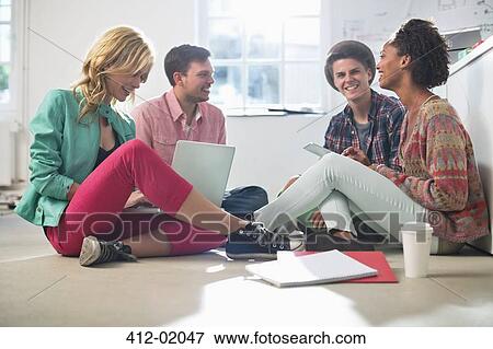 Business people talking on floor in office View Large Photo Image Stock Photo - Business people talking on floor in office. Fotosearch