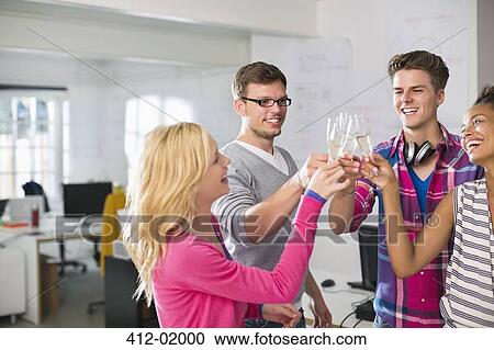 Business people toasting each other with champagne in office View Large Photo Image Stock Image - Business people toasting each other with champagne in office. Fotosearch