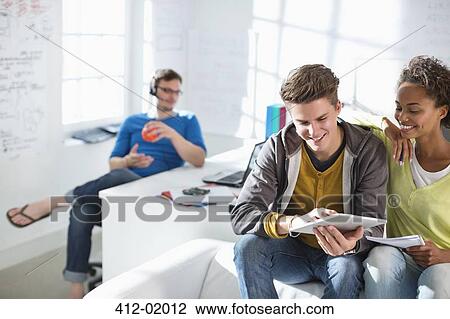 Stock Image - Business people using digital tablet in office. Fotosearch