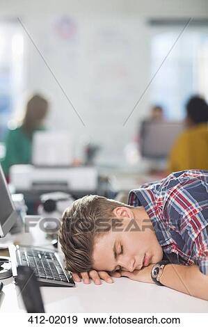 Stock Photo - Businessman sleeping at desk. Fotosearch