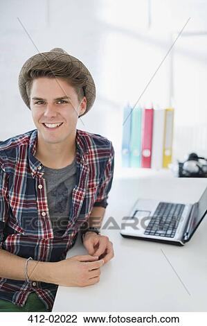 Businessman smiling at desk View Large Photo Image Stock Image - Businessman smiling at desk. Fotosearch
