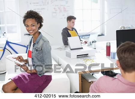 Stock Photography - Businesswoman using digital tablet in office. Fotosearch