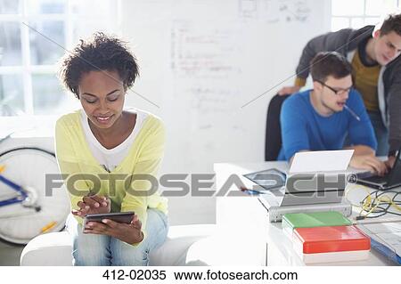 Stock Photography - Businesswoman using digital tablet in office. Fotosearch