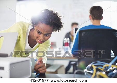 Businesswoman using printer at desk View Large Photo Image Stock Photo - Businesswoman using printer at desk. Fotosearch