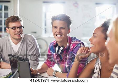 Friends talking at desk View Large Photo Image Picture - Friends talking at desk. Fotosearch