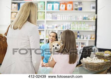 Owner bringing dog to vet's surgery View Large Photo Image Stock Photo - Owner bringing dog to vet's surgery. Fotosearch
