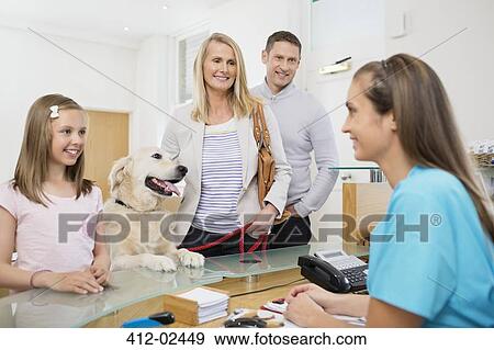 Stock Photo - Owners bringing dog to vet's surgery. Fotosearch