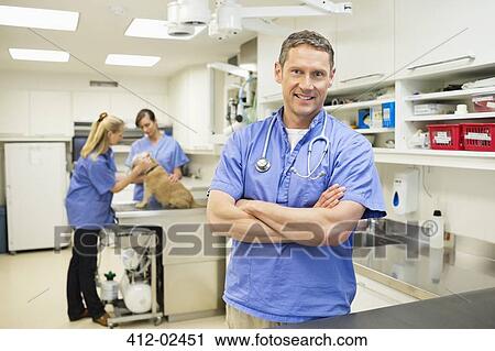 Smiling veterinarian standing in vet's surger View Large Photo Image Stock Image - Smiling veterinarian standing in vet's surger. Fotosearch