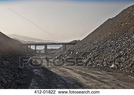 Bridge spanning road in quarry View Large Photo Image Stock Image - Bridge spanning road in quarry. Fotosearch