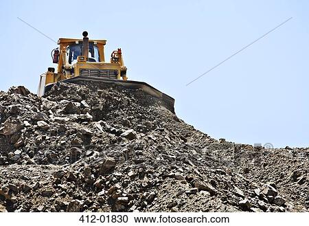 Bulldozer working in quarry View Large Photo Image Stock Image - Bulldozer working in quarry. Fotosearch