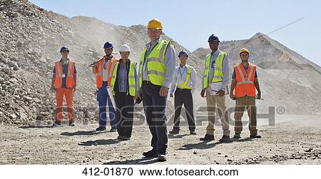 Business people and workers standing in quarry View Large Photo Image Stock Image - Business people and workers standing in quarry. Fotosearch