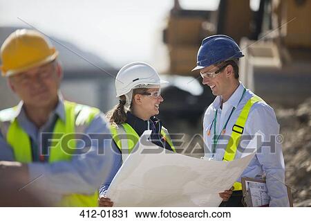 Business people reading blueprints in quarry View Large Photo Image Stock Image - Business people reading blueprints in quarry. Fotosearch
