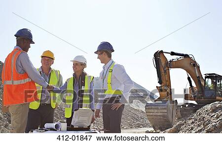 Business people shaking hands in quarry View Large Photo Image Stock Photo - Business people shaking hands in quarry. Fotosearch