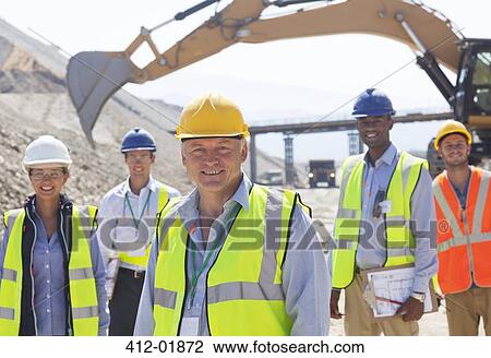 Business people standing in quarry View Large Photo Image Stock Image - Business people standing in quarry. Fotosearch