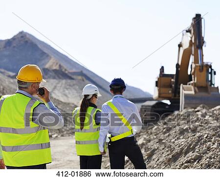 Business people talking in quarry View Large Photo Image Stock Photograph - Business people talking in quarry. Fotosearch