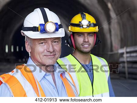 Businessman and worker smiling together View Large Photo Image Stock Image - Businessman and worker smiling together. Fotosearch