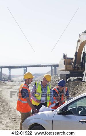 Businessman and workers talking in quarry View Large Photo Image Stock Image - Businessman and workers talking in quarry. Fotosearch