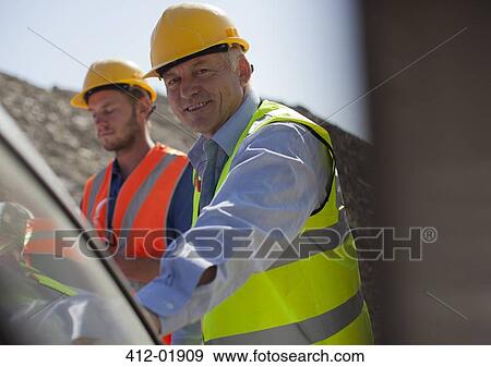 Businessman smiling in quarry View Large Photo Image Stock Photo - Businessman smiling in quarry. Fotosearch