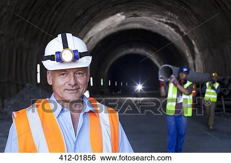 Businessman standing in tunnel View Large Photo Image Stock Photograph - Businessman standing in tunnel. Fotosearch