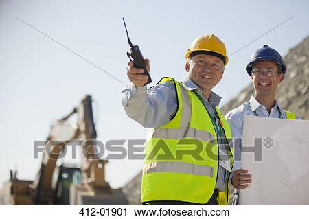 Businessmen talking in quarry View Large Photo Image Stock Image - Businessmen talking in quarry. Fotosearch
