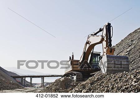 Digger working in quarry View Large Photo Image Stock Image - Digger working in quarry. Fotosearch