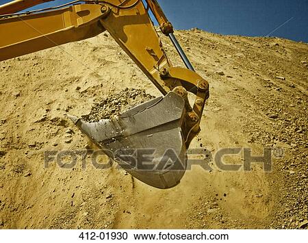 Stock Image - Digger working in quarry. Fotosearch
