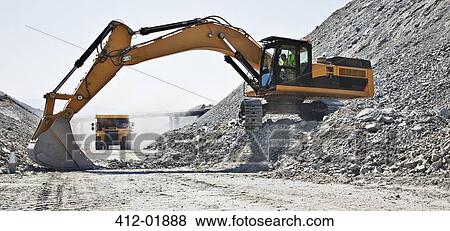 Digger working in quarry View Large Photo Image Stock Photo - Digger working in quarry. Fotosearch