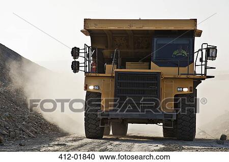 Machinery driving on road in quarry View Large Photo Image Stock Image - Machinery driving on road in quarry. Fotosearch