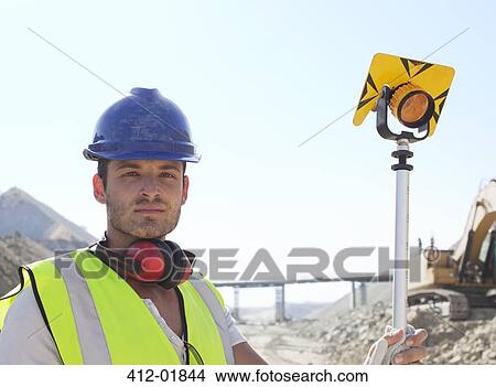 Worker standing in quarry View Large Photo Image Picture - Worker standing in quarry. Fotosearch