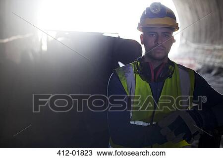 Worker standing in tunnel View Large Photo Image Stock Image - Worker standing in tunnel. Fotosearch