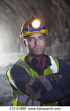 Worker standing in tunnel View Large Photo Image Stock Photo - Worker standing in tunnel. Fotosearch